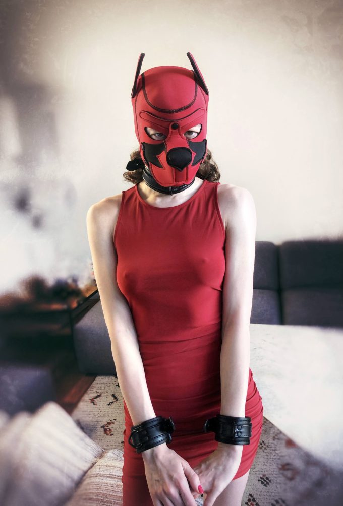 Banoch human puppy play model Darvinetta woman wearing red dress black cuffs and red neoprene dog mask scaled Banoch human puppy play model Darvinetta woman wearing red dress black cuffs and red neoprene dog mask scaled